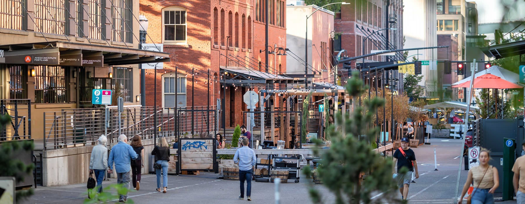 people walk down side street with local vendors